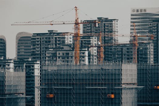 A view of a city under development with cranes and skyscrapers showcasing urban growth.