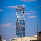 Architectural landmark, the twisted tower in Riyadh against a blue sky.