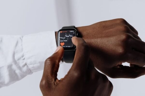 Close-up of a person interacting with a smartwatch for health tracking indoors.